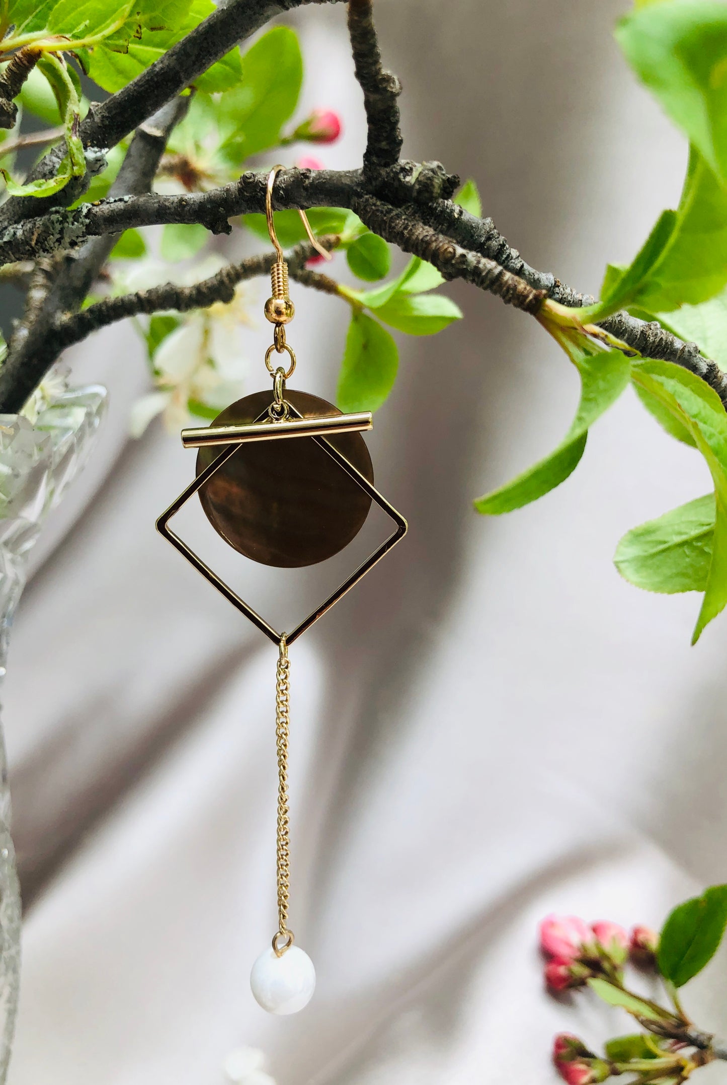 Golden Dangly Earrings with a White Accent